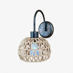 Bild in Gallery-Viewer laden, Shade A woven rattan wall sconce in antique brass