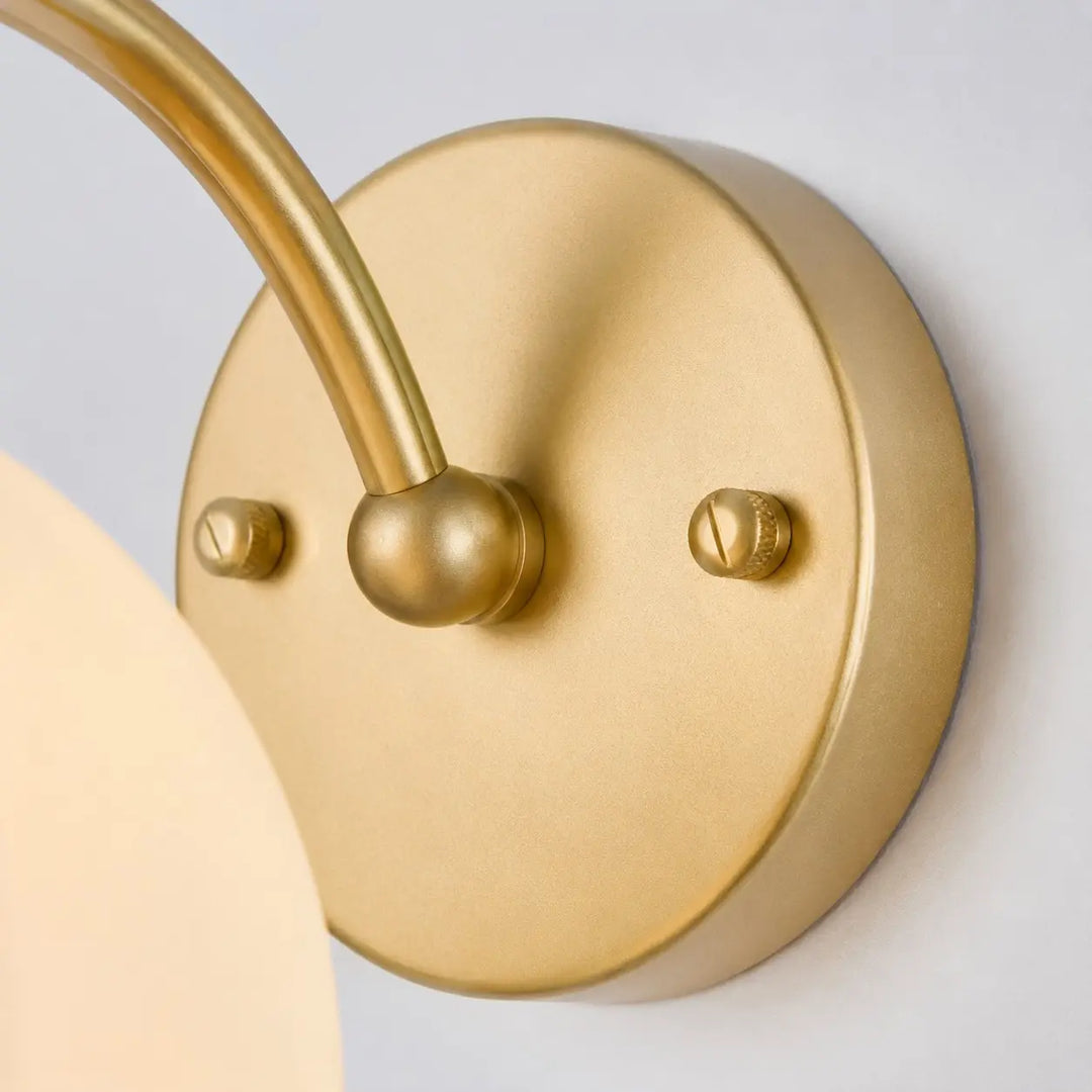 Close-up of the wall plate and curved lamp arm