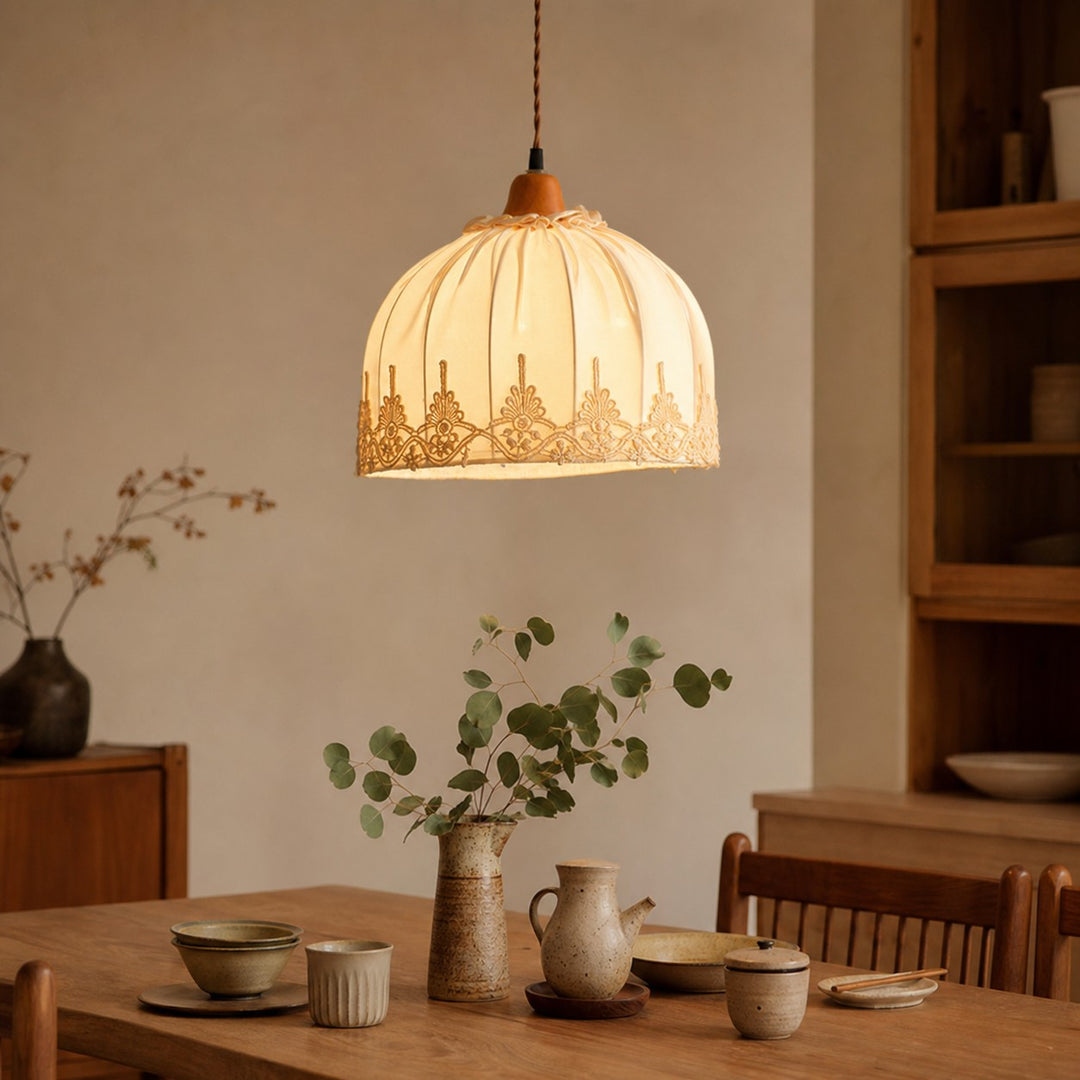 Vintage lace fabric pendant light above a dining table