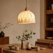 Vintage lace fabric pendant light above a dining table