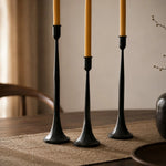 Cargar imagen en el visor de la Galería, Three black iron taper candle holders showing varied height and slim stems