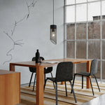 Bild in Gallery-Viewer laden, Black mesh stone pendant light over a dining table near a window