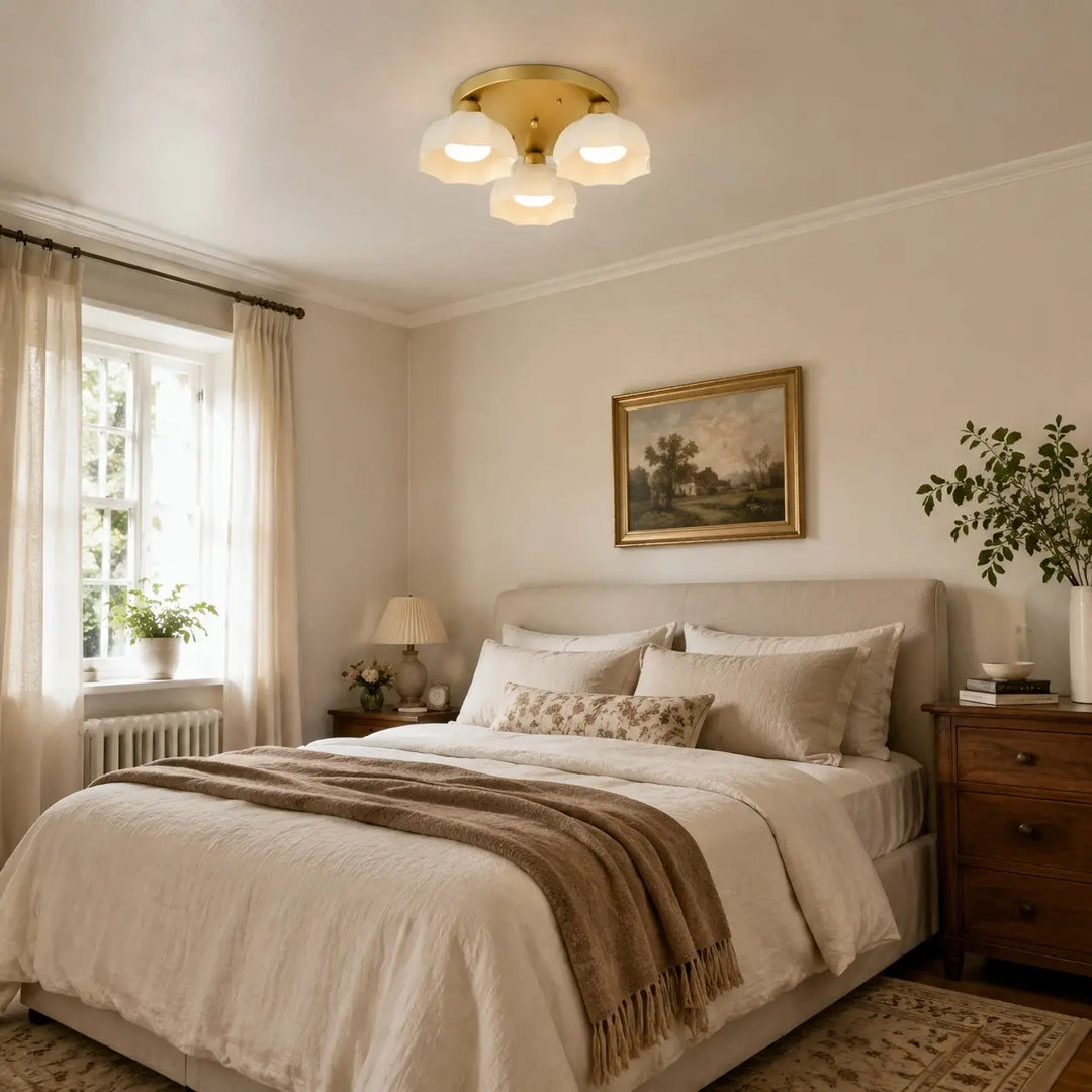 White glass flush mount light in a styled bedroom