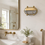 Cargar imagen en el visor de la Galería, Aplique de pared Ivoran Bulkhead - Luz industrial vintage de vidrio con jaula de latón para exteriores y baño