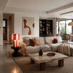 Cargar imagen en el visor de la Galería, Red and cream striped woven table lamp glowing in a living room