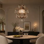 Load image into Gallery viewer, Clear crystal pendant light above a dining table