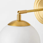 Load image into Gallery viewer, Close view of the gold arm and milk glass shade connection