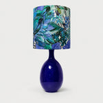 Load image into Gallery viewer, Green botanical fabric ceramic table lamp on plain background