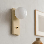 Charger l'image dans la visionneuse de galerie, Close view of installed cream glass globe wall sconce