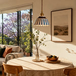 Load image into Gallery viewer, Striped ceramic pendant lamp in a sunlit dining nook