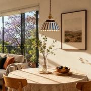 Striped ceramic pendant lamp in a sunlit dining nook