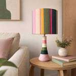 Charger l'image dans la visionneuse de galerie, Colorful striped ceramic table lamp with cotton thread wrapped exterior in a cozy living room corner