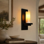 Bild in Gallery-Viewer laden, Rustic black metal wall sconce in a living room setting