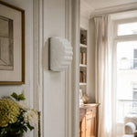 Cargar imagen en el visor de la Galería, White glass wall sconce installed beside a bright living room