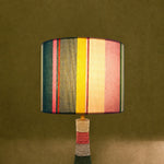 Charger l'image dans la visionneuse de galerie, Colorful striped table lamp switched on with warm ambient light