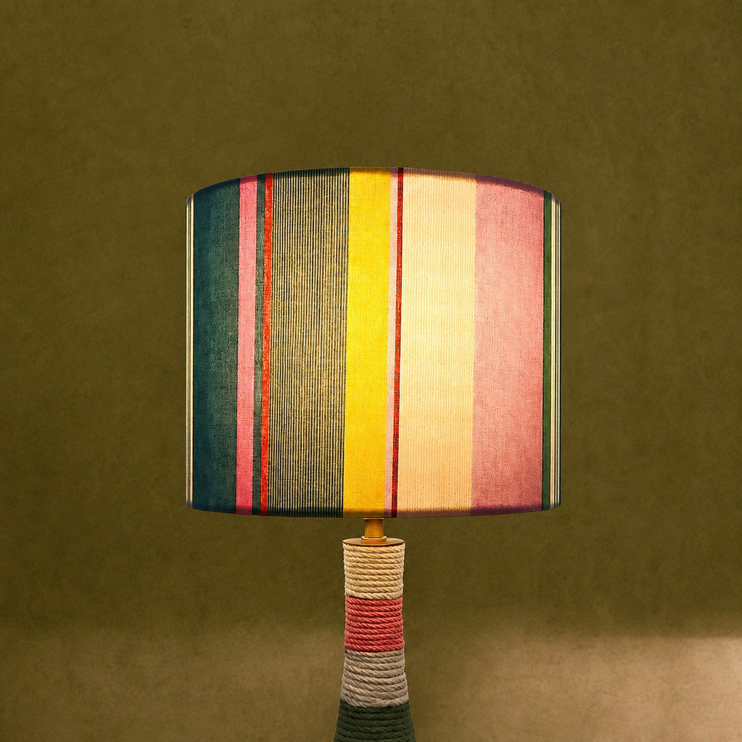 Colorful striped table lamp switched on with warm ambient light