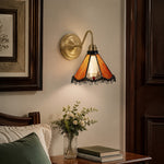 Load image into Gallery viewer, Orange stained glass wall sconce beside a vanity mirror