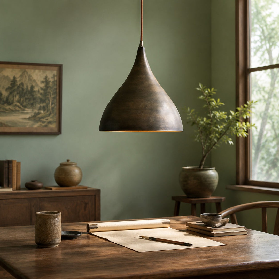 Aged brass pendant light over a dining table with soft daylight