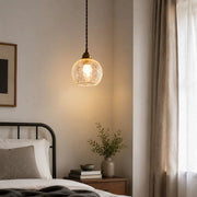 brass glass pendant light used as warm bedside lighting