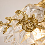 Charger l'image dans la visionneuse de galerie, Close-up of floral glass shade and brass-tone flower detail