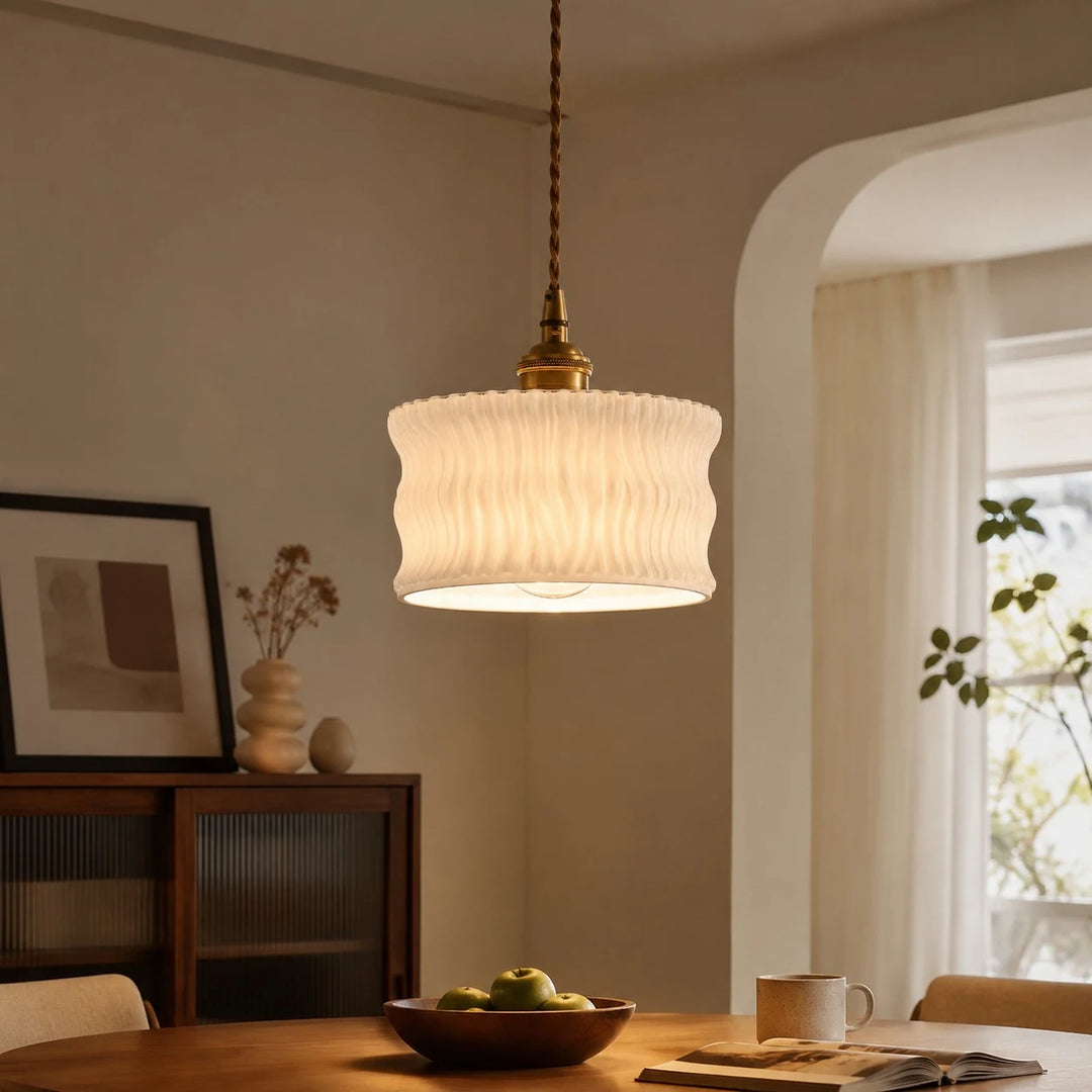 Frosted white ripple glass pendant above a dining table