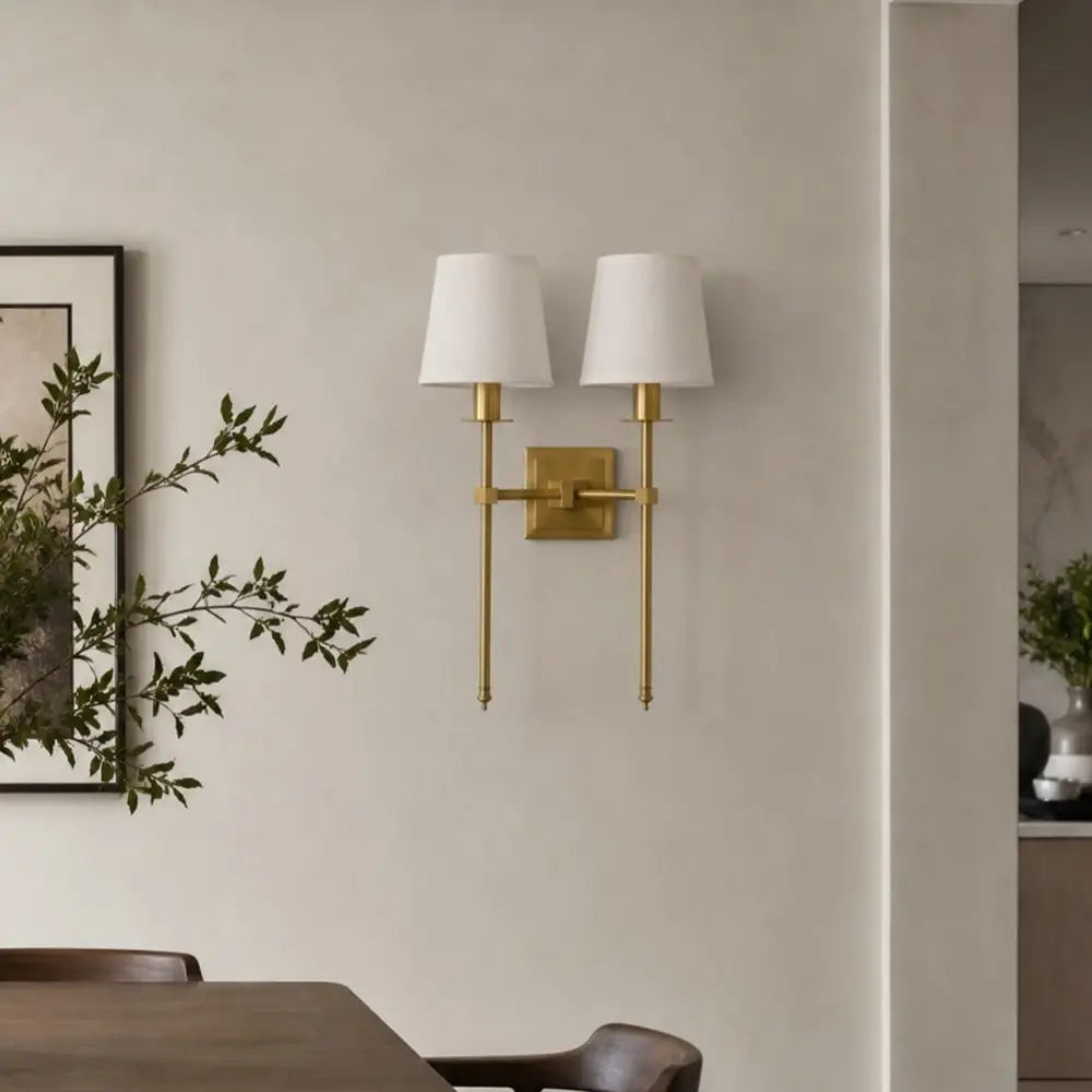 Double Head brass wall sconce in a modern dining room