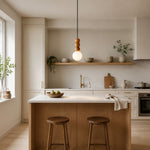 Cargar imagen en el visor de la Galería, Wood bead globe pendant centered over a modern kitchen island