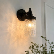 Wall sconce casting warm light in a hallway corner