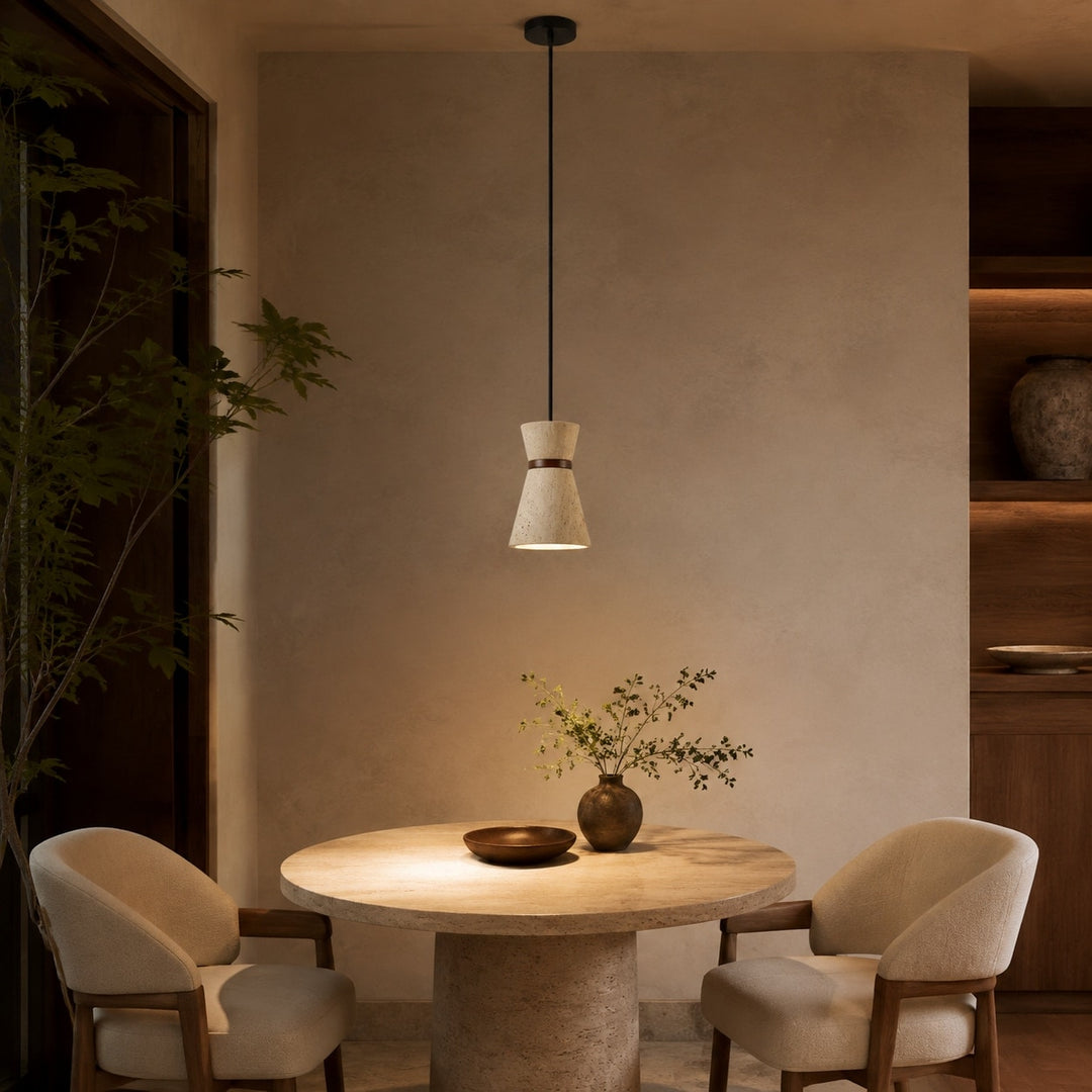 Single travertine pendant light above a round dining table