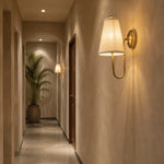 Bild in Gallery-Viewer laden, Brass fabric wall sconce lighting a hallway wall