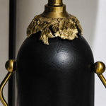 Load image into Gallery viewer, Close-up of matte black lamp body with antique brass-toned floral detail