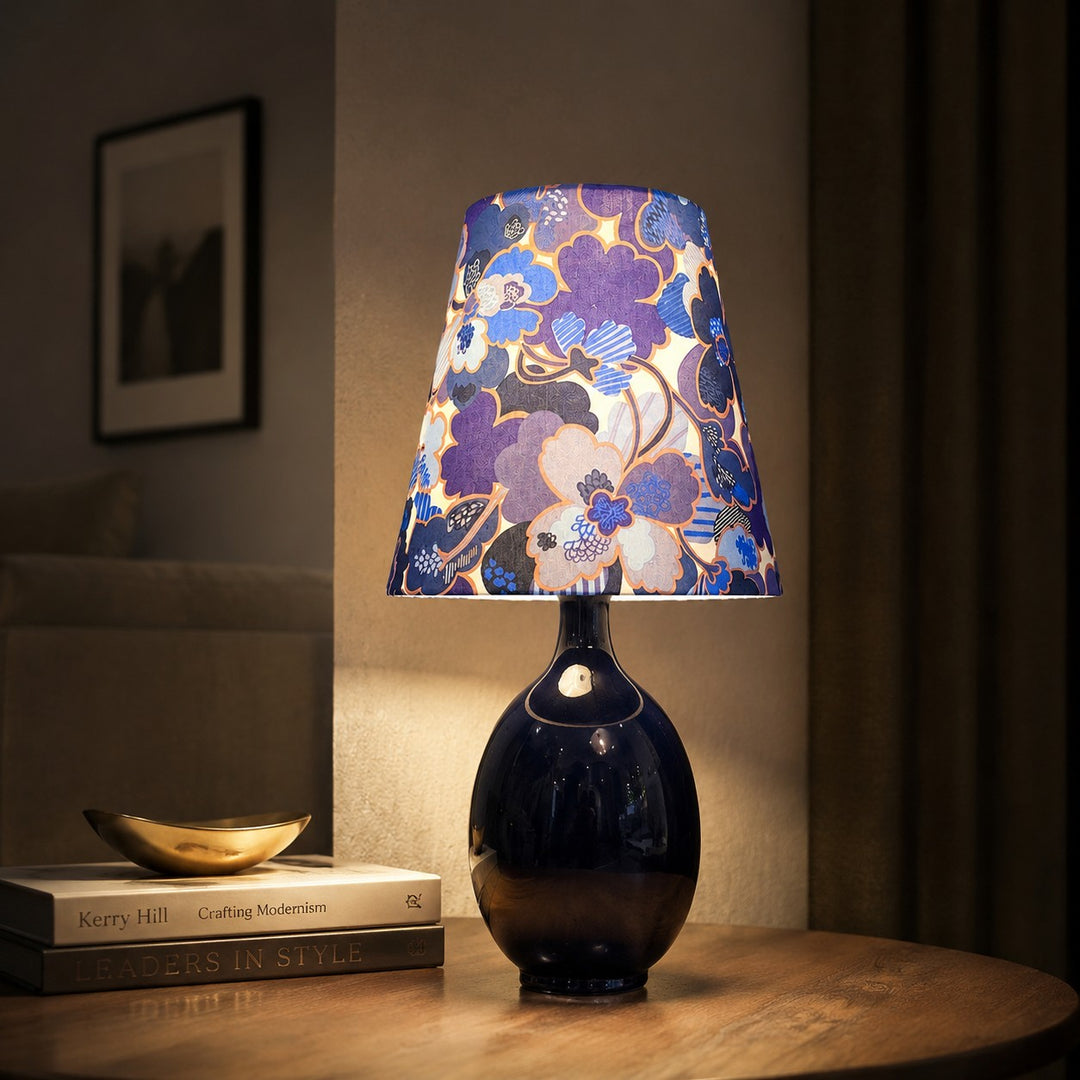 Blue floral fabric ceramic table lamp on a bedside table