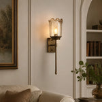 Load image into Gallery viewer, Brass amber glass wall sconce in a living room corner