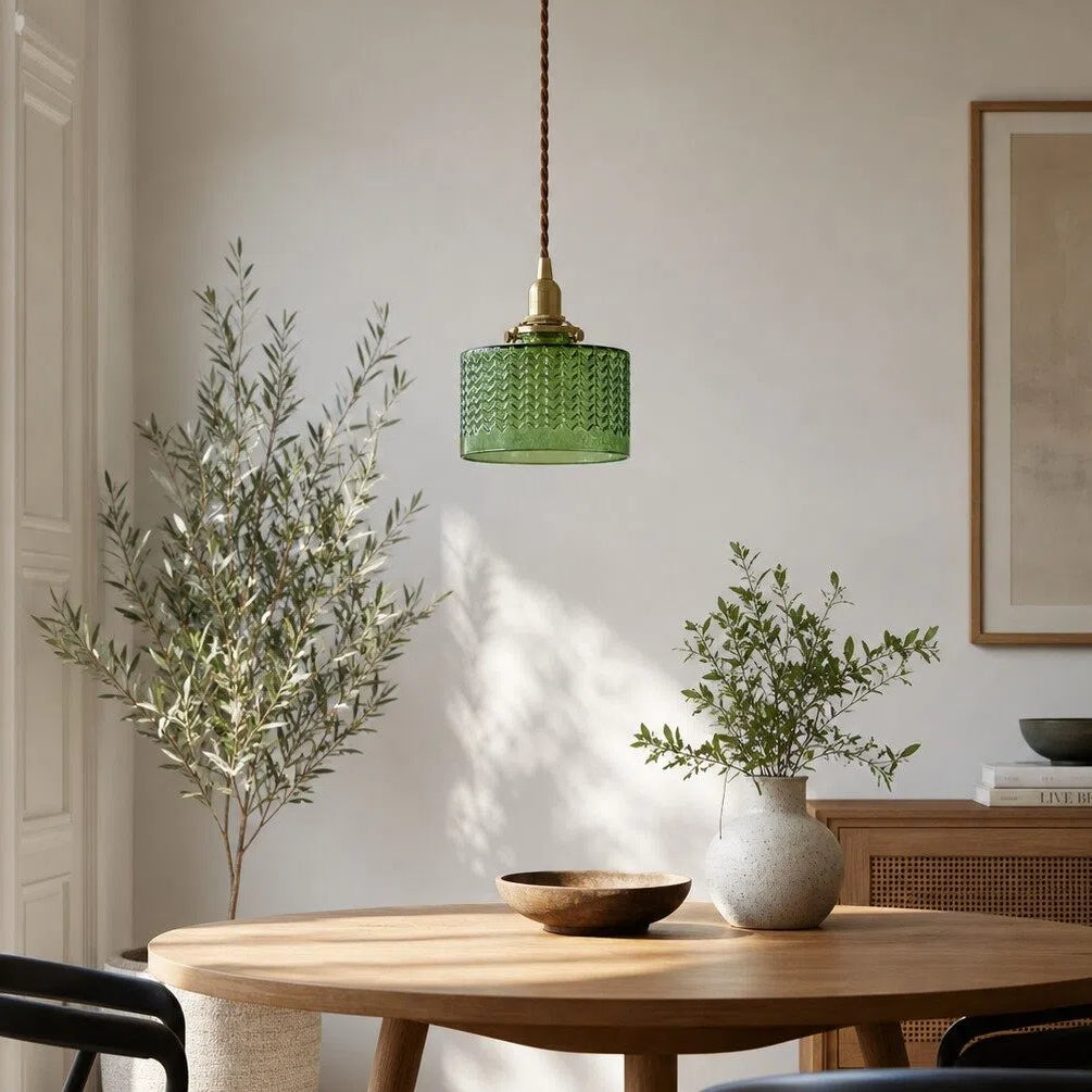 Emerald glass pendant above a dining table
