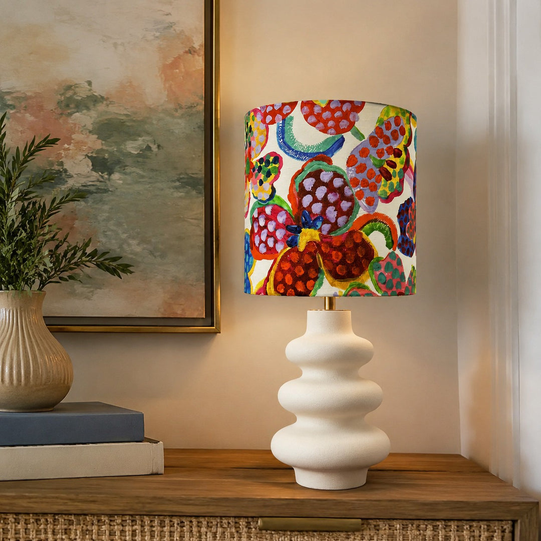 Colorful floral shade table lamp styled beside books