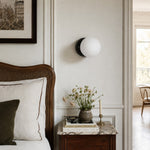 Bild in Gallery-Viewer laden, Black Marble globe wall sconce above a bedside table