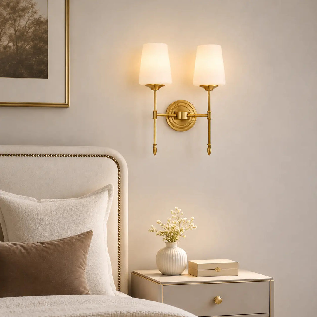 Vintage brass wall light creating a warm bedroom atmosphere