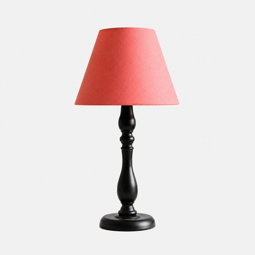 Vintage black iron table lamp with washed red fabric shade
