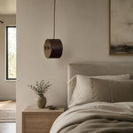 Bild in Gallery-Viewer laden, Hand-laced leather cylinder pendant light in an interior setting