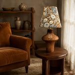 Cargar imagen en el visor de la Galería, Blue floral ceramic table lamp beside a lounge chair