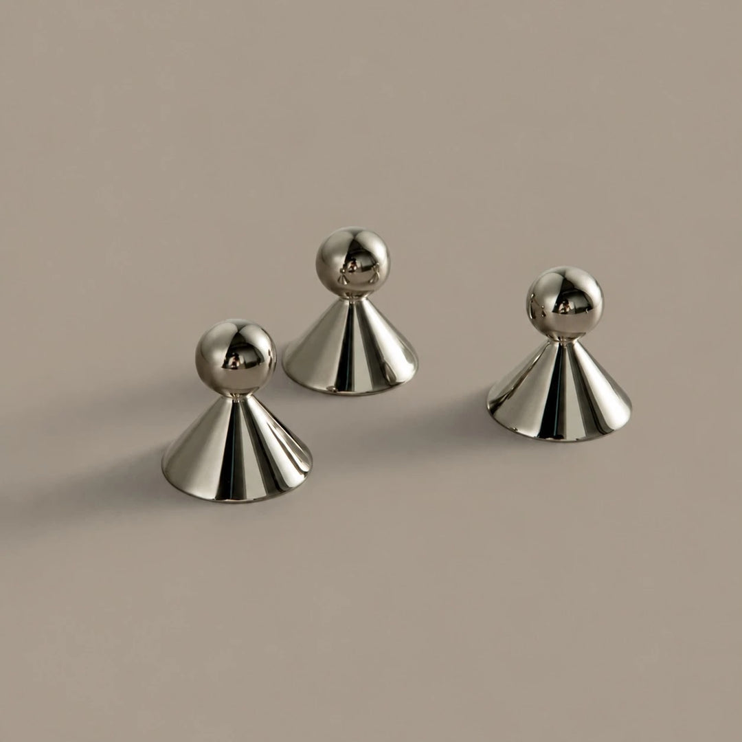 Sculptural brass cabinet knobs shown from several angles