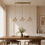 Cargar imagen en el visor de la Galería, Three clear flower pendants over a wood dining table