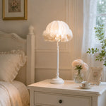 Bild in Gallery-Viewer laden, Ruffled table lamp glowing on a white bedside dresser in a bright bedroom