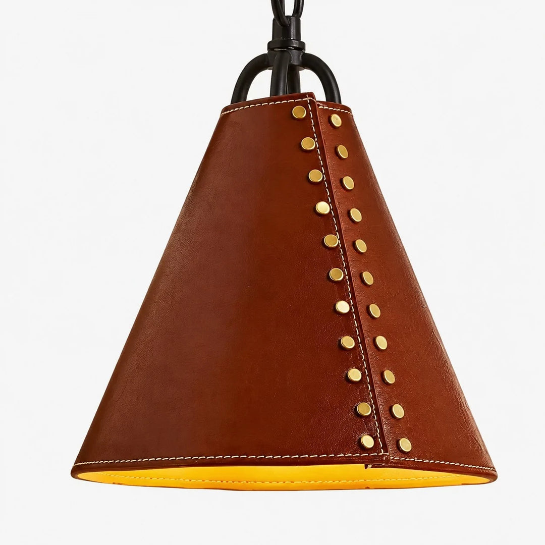 Close view of red leather cone shade with gold rivets and stitched lower edge