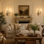 Load image into Gallery viewer, Two-light wall sconces installed beside a traditional living room fireplace