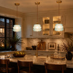 Load image into Gallery viewer, Three pendant lights glowing above a kitchen island