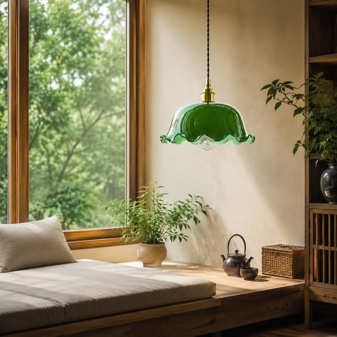 Green glass pendant light by a sofa and window
