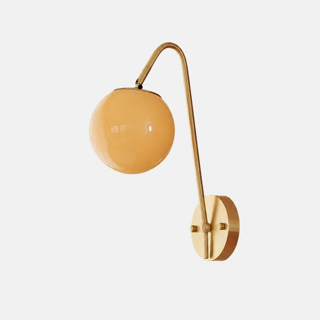 French brass wall light with amber glass globe shade