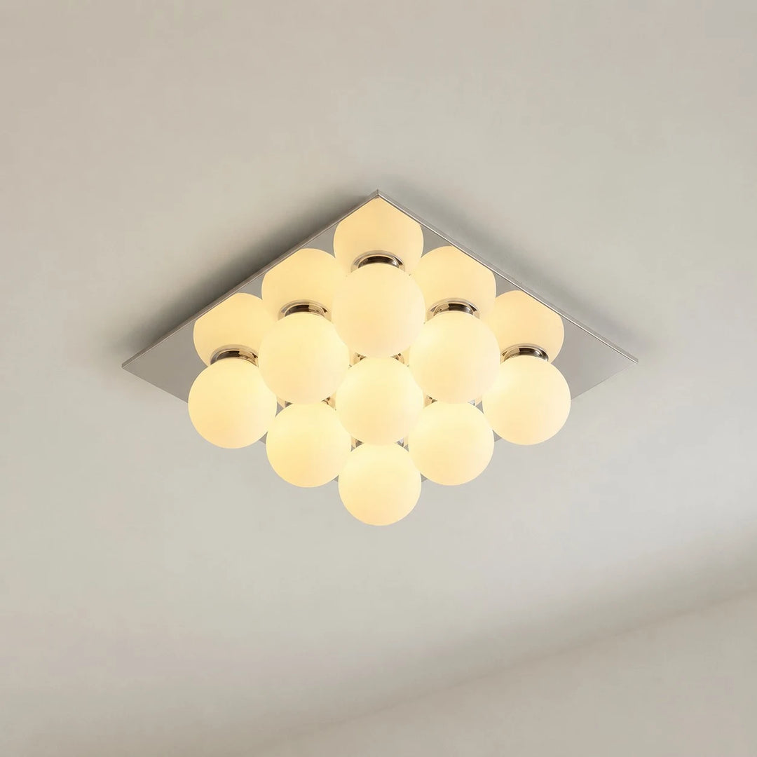 Gallery image: nine glowing glass globes under a square chrome canopy.