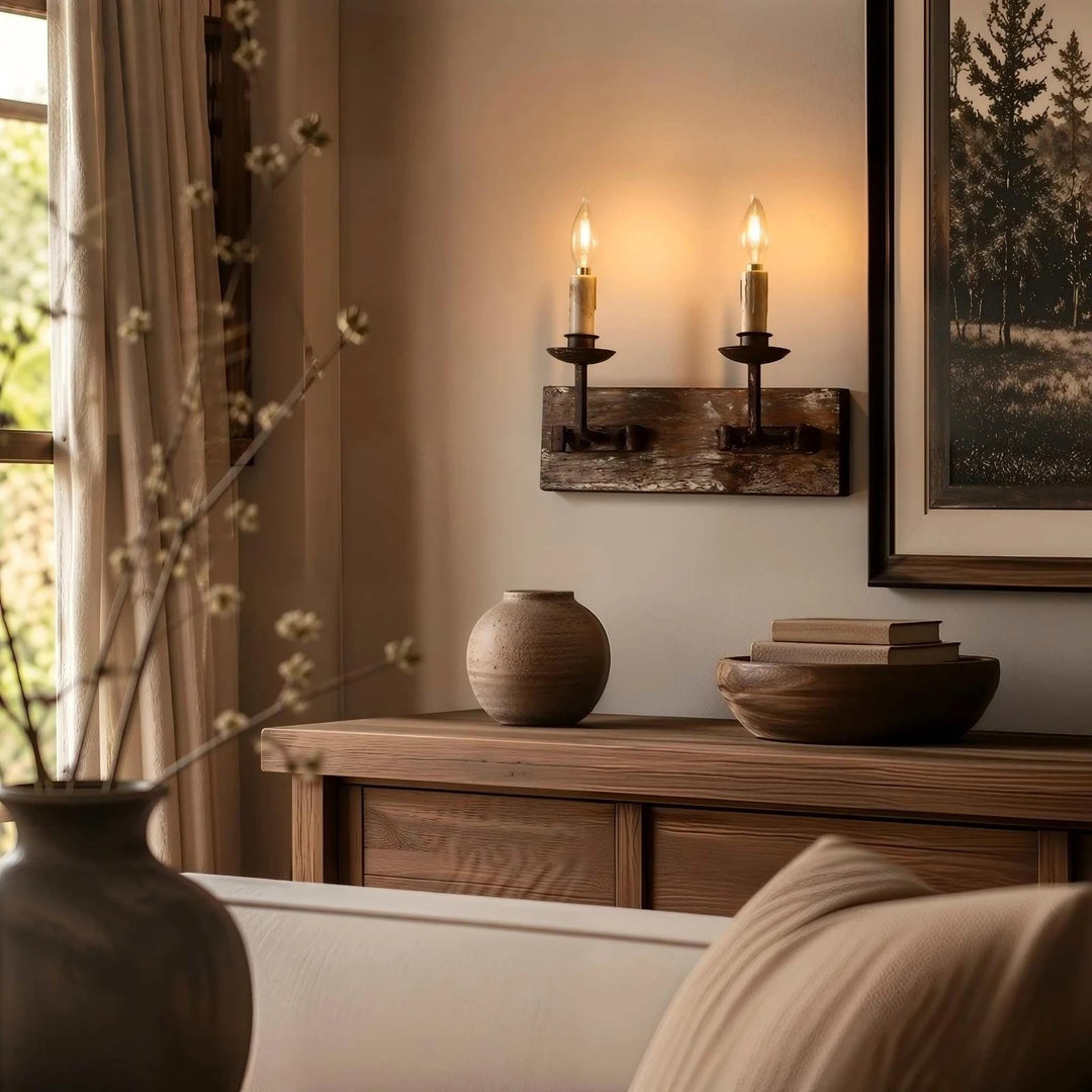 Two light rustic candle wall sconce glowing above a wooden console